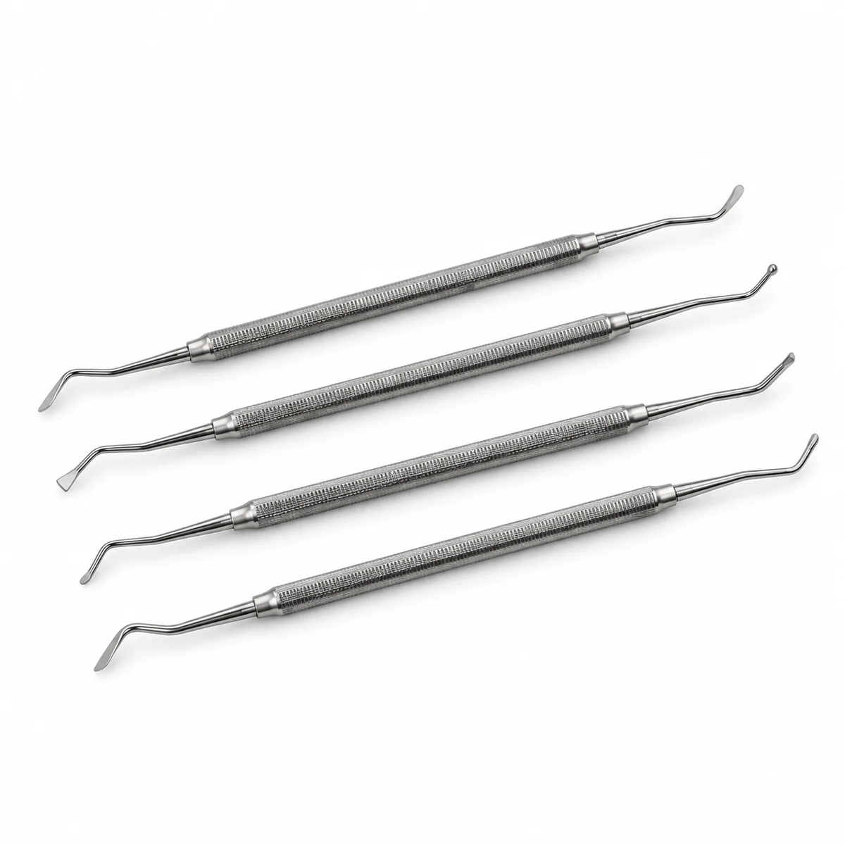 Four double-ended stainless steel dental pluggers, on a white background