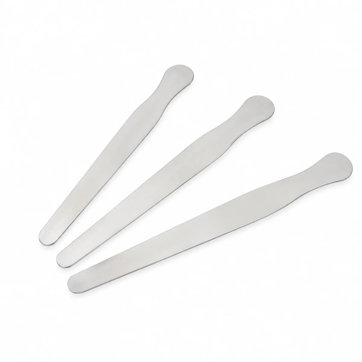 Three stainless steel tongue depressors, on a white background